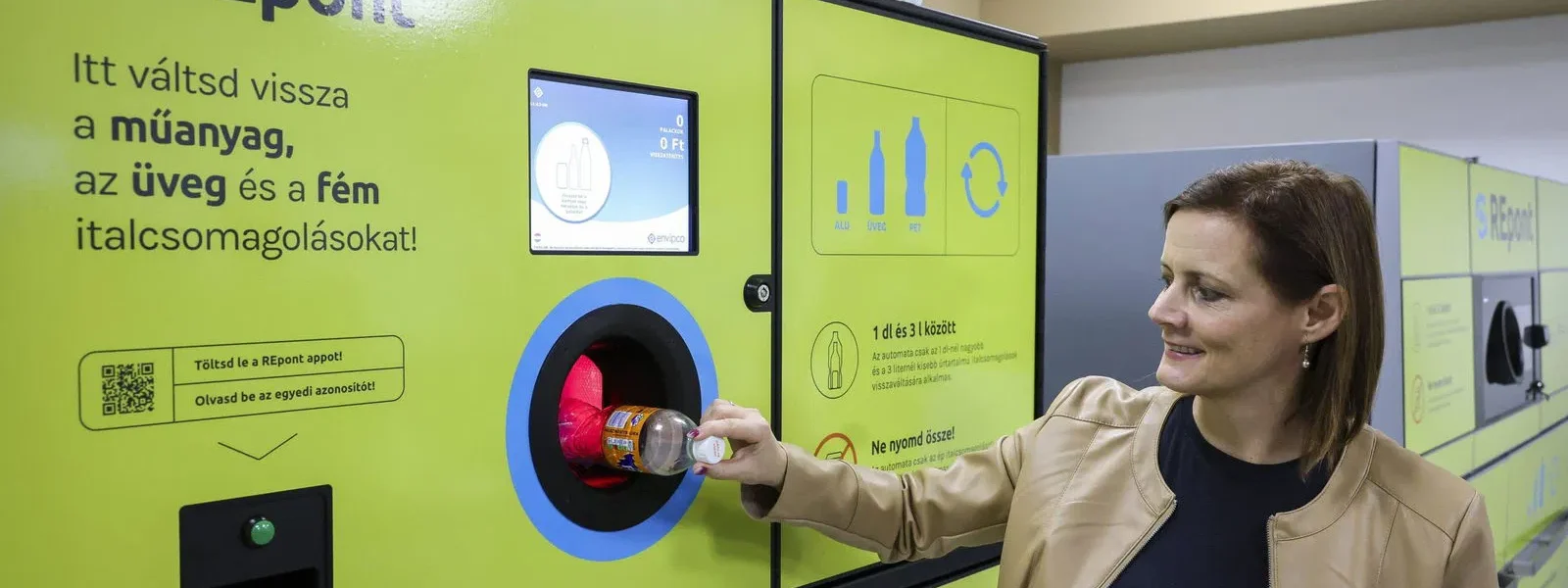 Egy nő palackot vált vissza egy palackvisszaváltó automatánál.